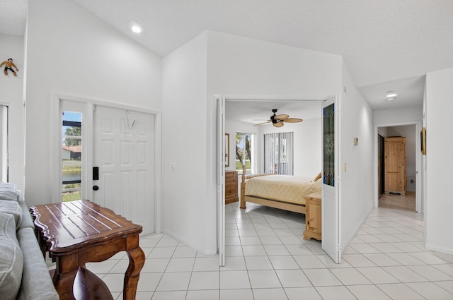 3010 NW 12th St Unit D, Delray Beach, FL 33445 - entryway with ceiling fan, light tile patterned flooring, a textured ceiling, and a high ceiling