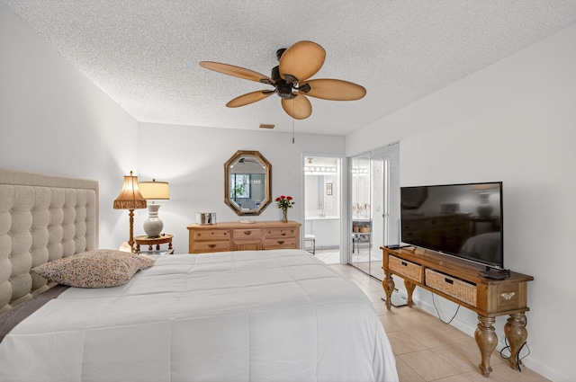 3010 NW 12th St Unit D, Delray Beach, FL 33445 - bedroom with light tile patterned floors, connected bathroom, a textured ceiling, and a ceiling fan