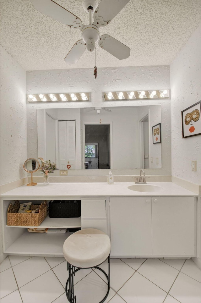 3010 NW 12th St Unit D, Delray Beach, FL 33445 - bathroom featuring a textured wall, vanity, tile patterned flooring, a ceiling fan, and a textured ceiling