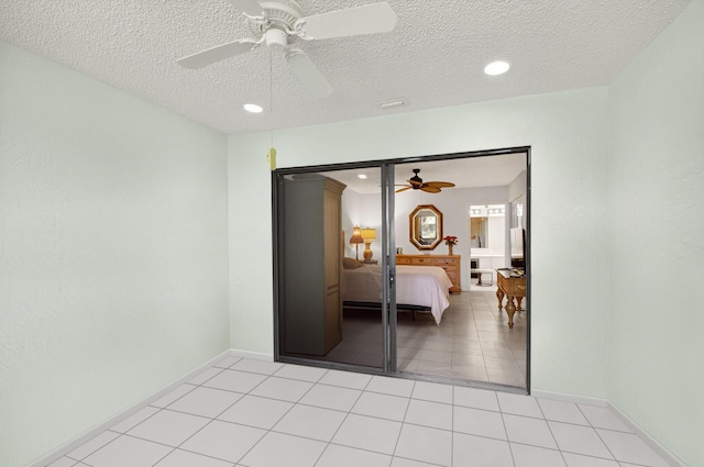 3010 NW 12th St Unit D, Delray Beach, FL 33445 - bedroom with light tile patterned flooring, a textured ceiling, recessed lighting, and a ceiling fan