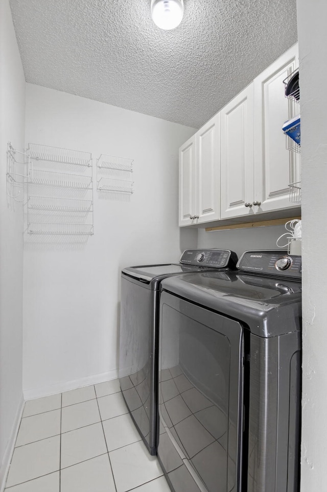 3010 NW 12th St Unit D, Delray Beach, FL 33445 - laundry area with independent washer and dryer, cabinet space, a textured ceiling, and light tile patterned floors