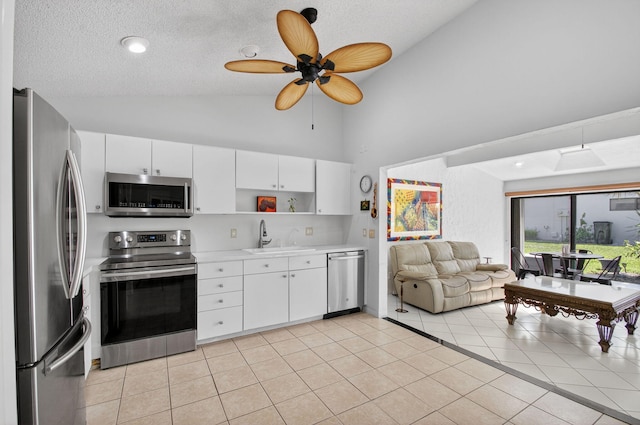 3010 NW 12th St Unit D, Delray Beach, FL 33445 - kitchen with stainless steel appliances, light countertops, open shelves, open floor plan, and high vaulted ceiling