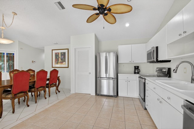 3010 NW 12th St Unit D, Delray Beach, FL 33445 - kitchen with appliances with stainless steel finishes, open shelves, light countertops, light tile patterned flooring, and a ceiling fan