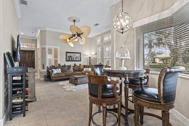801 SW Classico Ct, Port Saint Lucie, FL 34986 - dining area featuring a chandelier, crown molding, light tile patterned floors, healthy amount of natural light, and a high ceiling