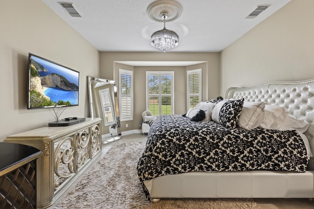801 SW Classico Ct, Port Saint Lucie, FL 34986 - carpeted bedroom with a chandelier and baseboards