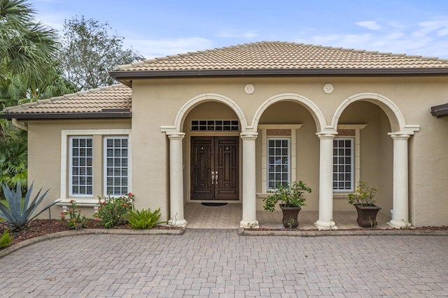 801 SW Classico Ct, Port Saint Lucie, FL 34986 - entrance to property with a tile roof and stucco siding