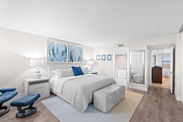 5280 N Ocean Dr Unit 3B, Singer Island, FL 33404 - bedroom featuring wood finished floors and ensuite bathroom