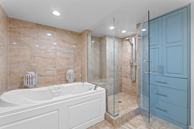 5280 N Ocean Dr Unit 3B, Singer Island, FL 33404 - bathroom featuring a bath, a shower stall, marble finish floors, and recessed lighting