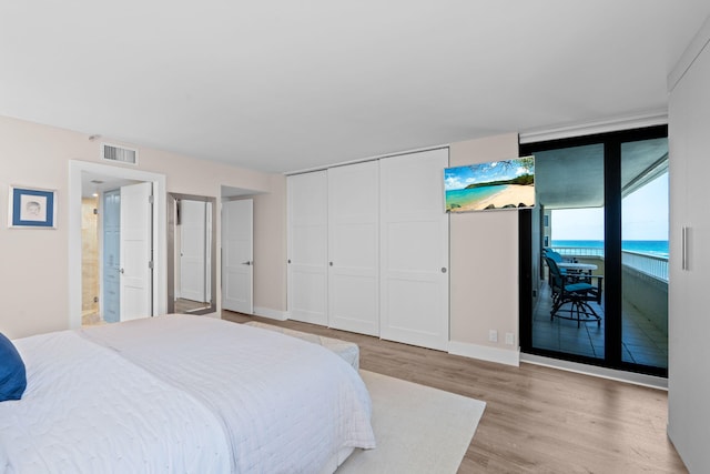 5280 N Ocean Dr Unit 3B, Singer Island, FL 33404 - bedroom featuring access to exterior, light wood-type flooring, and a closet