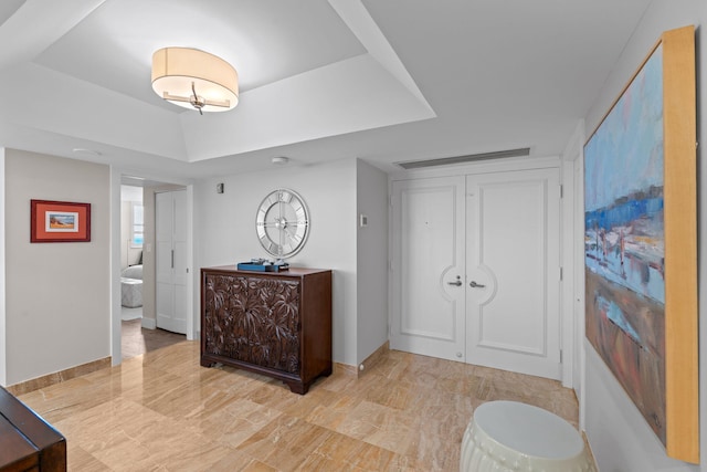5280 N Ocean Dr Unit 3B, Singer Island, FL 33404 - entrance foyer with baseboards and a tray ceiling