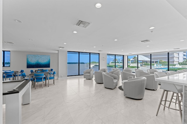 5280 N Ocean Dr Unit 3B, Singer Island, FL 33404 - living area featuring floor to ceiling windows, light marble finish flooring, and recessed lighting