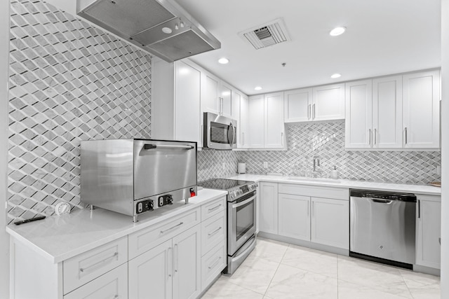 5280 N Ocean Dr Unit 3B, Singer Island, FL 33404 - kitchen with appliances with stainless steel finishes, light marble finish flooring, extractor fan, white cabinets, and recessed lighting