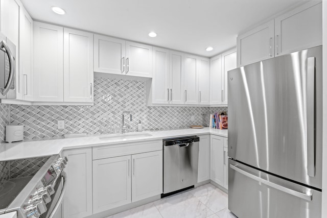5280 N Ocean Dr Unit 3B, Singer Island, FL 33404 - kitchen with appliances with stainless steel finishes, light countertops, white cabinetry, decorative backsplash, and recessed lighting