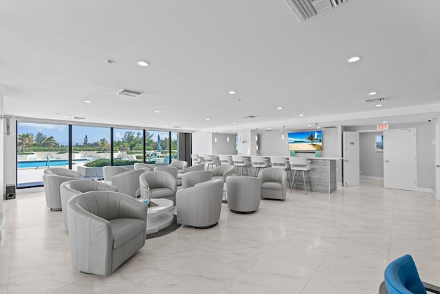 5280 N Ocean Dr Unit 3B, Singer Island, FL 33404 - living area with recessed lighting, light marble finish floors, plenty of natural light, and a wall of windows