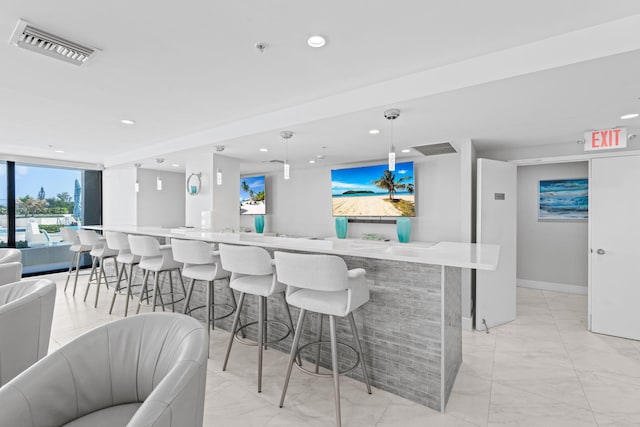 5280 N Ocean Dr Unit 3B, Singer Island, FL 33404 - kitchen with open floor plan, light marble finish floors, recessed lighting, a kitchen breakfast bar, and pendant lighting
