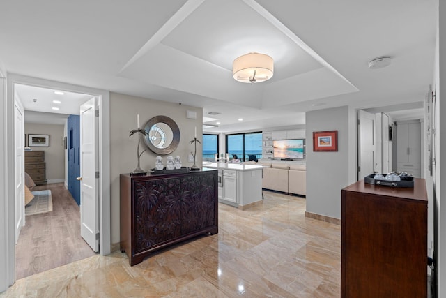 5280 N Ocean Dr Unit 3B, Singer Island, FL 33404 - hallway with a raised ceiling and baseboards