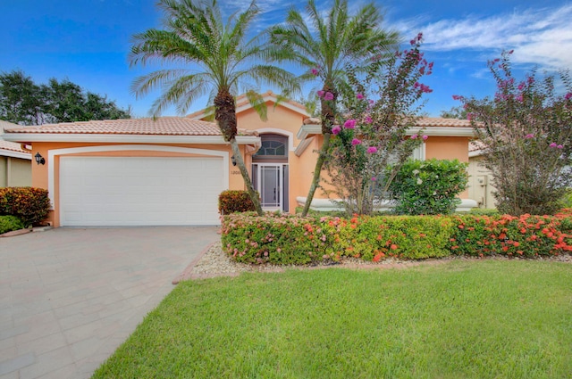 12086 Aprilia Dr, Boynton Beach, FL 33437 - view of front facade featuring a tiled roof, a garage, stucco siding, and driveway