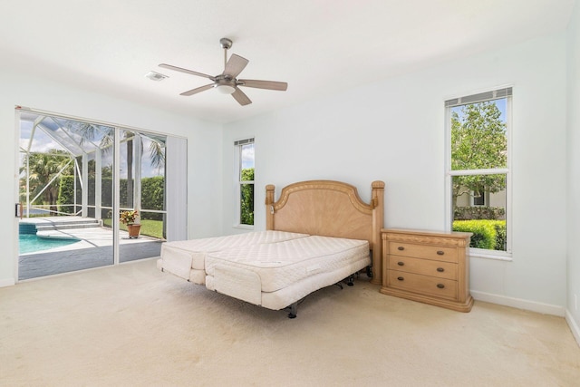 6025 Fountain Palm Dr, Jupiter, FL 33458 - bedroom featuring access to exterior, light colored carpet, multiple windows, and ceiling fan