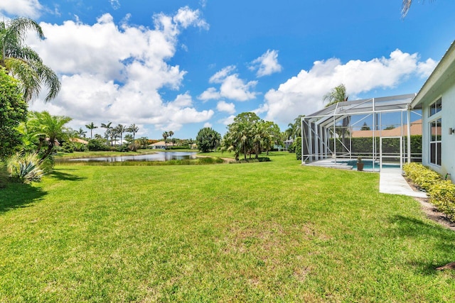 6025 Fountain Palm Dr, Jupiter, FL 33458 - view of green lawn with a water view, a lanai, and an outdoor pool