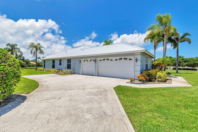6025 Fountain Palm Dr, Jupiter, FL 33458 - ranch-style house featuring an attached garage, a front lawn, driveway, a metal roof, and stucco siding