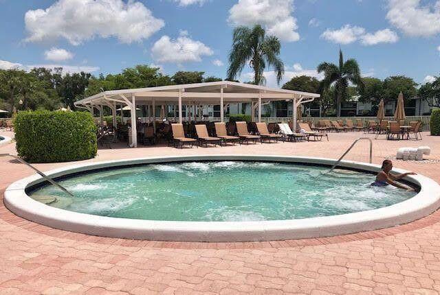 15378 Lakes Of Delray Blvd Unit 15, Delray Beach, FL 33484 - community pool featuring a patio area