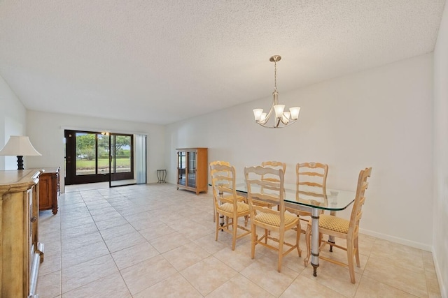 15378 Lakes Of Delray Blvd Unit 15, Delray Beach, FL 33484 - dining area with a chandelier, light tile patterned flooring, and a textured ceiling