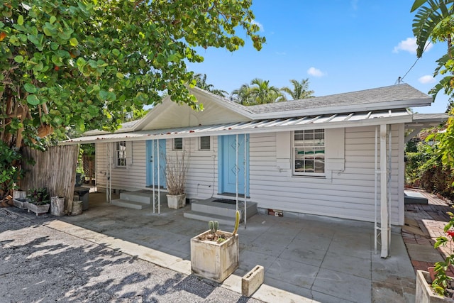 4621 N Ocean Blvd, Boynton Beach, FL 33435 - view of front of home featuring a patio area and a shingled roof
