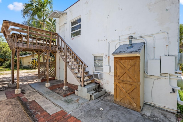 4621 N Ocean Blvd, Boynton Beach, FL 33435 - view of property exterior with stairs, stucco siding, and cooling unit