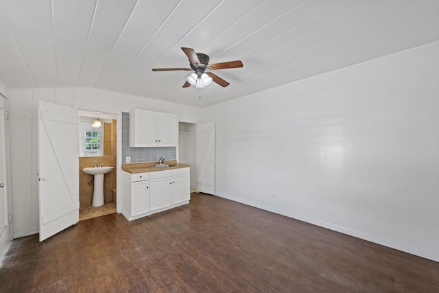 4621 N Ocean Blvd, Boynton Beach, FL 33435 - unfurnished living room with dark wood-style flooring, ceiling fan, and vaulted ceiling