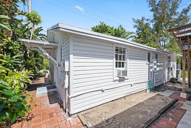 4621 N Ocean Blvd, Boynton Beach, FL 33435 - view of side of property with a patio and cooling unit