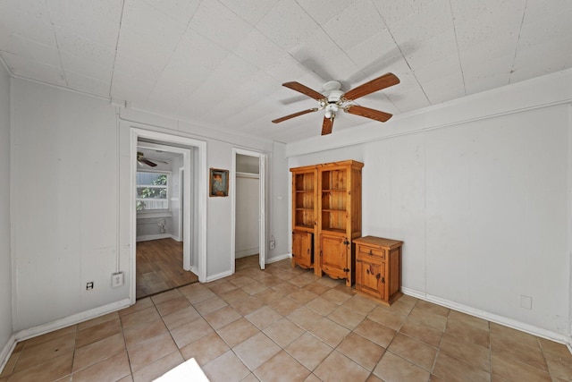 4621 N Ocean Blvd, Boynton Beach, FL 33435 - unfurnished bedroom with light tile patterned flooring and a ceiling fan