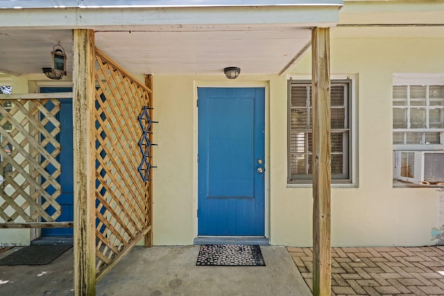4621 N Ocean Blvd, Boynton Beach, FL 33435 - property entrance with stucco siding and cooling unit