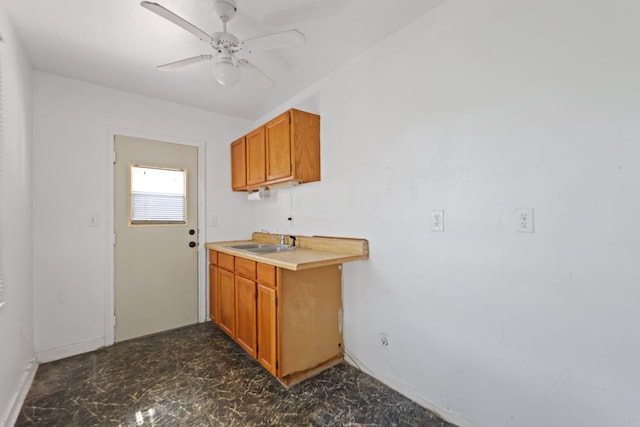 4621 N Ocean Blvd, Boynton Beach, FL 33435 - kitchen with a ceiling fan, brown cabinetry, light countertops, and dark marble finish floors