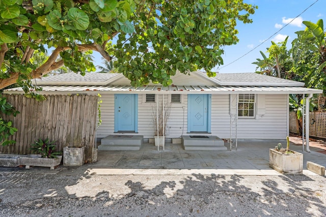 4621 N Ocean Blvd, Boynton Beach, FL 33435 - view of front facade with a shingled roof and a patio area
