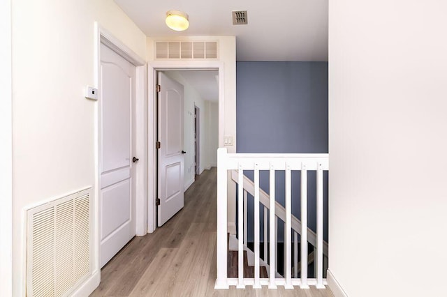 2113 SE Fern Park Dr, Port Saint Lucie, FL 34952 - hallway with light wood-style floors and an upstairs landing