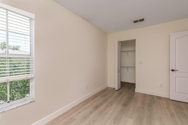 2113 SE Fern Park Dr, Port Saint Lucie, FL 34952 - unfurnished bedroom with light wood-style floors and a closet