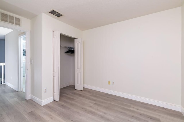 2113 SE Fern Park Dr, Port Saint Lucie, FL 34952 - unfurnished bedroom with light wood-style flooring and a closet