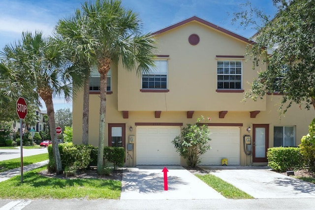 2113 SE Fern Park Dr, Port Saint Lucie, FL 34952 - townhome / multi-family property with stucco siding, driveway, and an attached garage