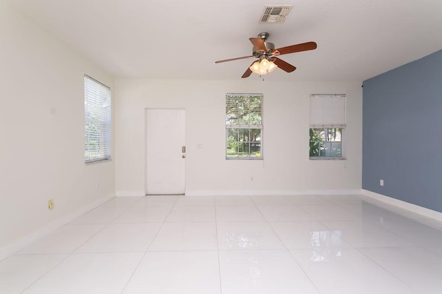 2113 SE Fern Park Dr, Port Saint Lucie, FL 34952 - empty room with a ceiling fan and light tile patterned floors