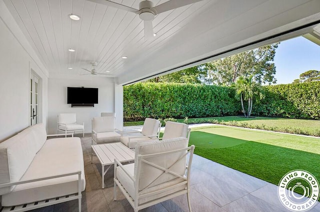 4941 S Lake Dr, Boynton Beach, FL 33436 - fenced backyard featuring ceiling fan, a patio area, a putting green, and an outdoor hangout area