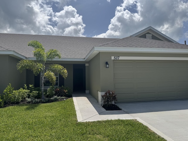 5117 Modeno St, Fort Pierce, FL 34951 - single story home featuring stucco siding, a front lawn, a shingled roof, and concrete driveway