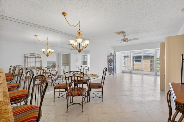 1111 Lemon Tree Ter Unit 204, Delray Beach, FL 33445 - dining area featuring a textured ceiling, a chandelier, ceiling fan, and light tile patterned floors