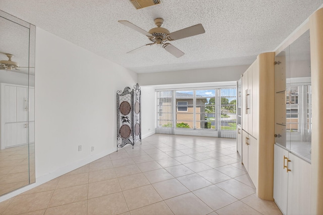 1111 Lemon Tree Ter Unit 204, Delray Beach, FL 33445 - empty room featuring a textured ceiling, ceiling fan, and light tile patterned flooring