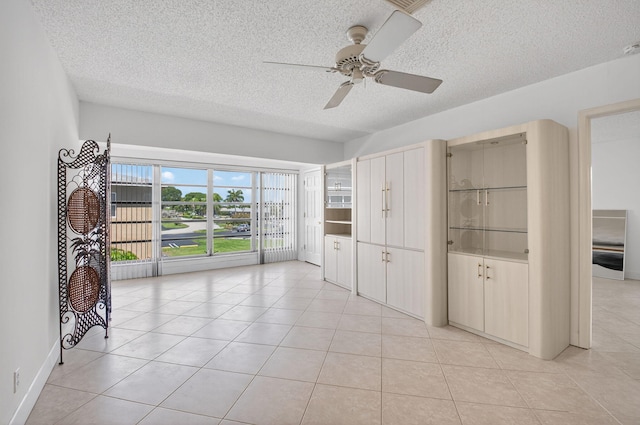 1111 Lemon Tree Ter Unit 204, Delray Beach, FL 33445 - unfurnished room with a ceiling fan, a textured ceiling, and light tile patterned floors