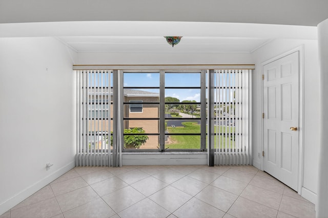 1111 Lemon Tree Ter Unit 204, Delray Beach, FL 33445 - empty room featuring light tile patterned flooring and crown molding