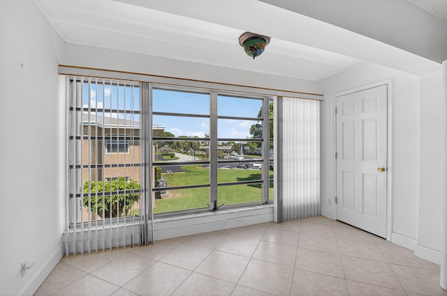 1111 Lemon Tree Ter Unit 204, Delray Beach, FL 33445 - unfurnished bedroom with light tile patterned floors and ornamental molding