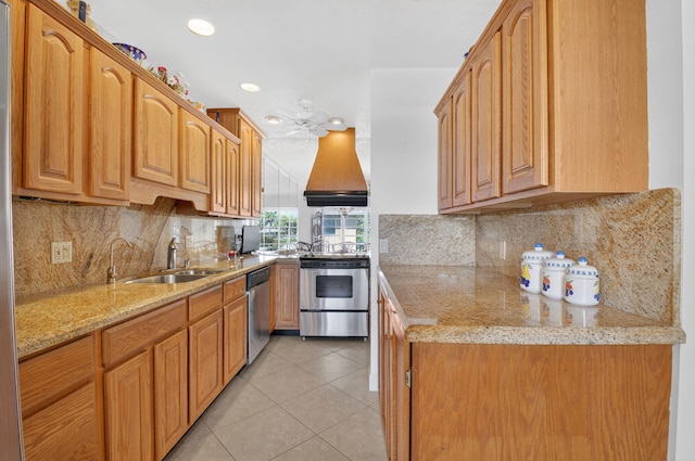 1111 Lemon Tree Ter Unit 204, Delray Beach, FL 33445 - kitchen with stainless steel appliances, custom range hood, light stone counters, light tile patterned flooring, and decorative backsplash