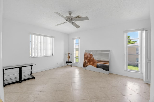 1111 Lemon Tree Ter Unit 204, Delray Beach, FL 33445 - unfurnished living room with a ceiling fan, a textured ceiling, and tile patterned flooring