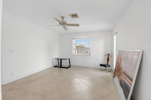 1111 Lemon Tree Ter Unit 204, Delray Beach, FL 33445 - unfurnished room featuring a ceiling fan, a textured ceiling, and light tile patterned floors