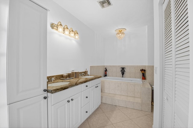 1111 Lemon Tree Ter Unit 204, Delray Beach, FL 33445 - bathroom with a closet, tile patterned flooring, a garden tub, and double vanity